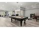 Billiards room with statement lighting, stylish billiard table and equipment; an ideal space for entertainment at 303 Rolling Rock Se Rd, Marietta, GA 30067