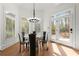 Dining area with lots of natural light, modern chandelier, and views of the backyard at 303 Rolling Rock Se Rd, Marietta, GA 30067