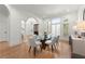 Formal dining room featuring hardwood floors, arched windows, and glass-top table at 303 Rolling Rock Se Rd, Marietta, GA 30067