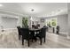 Bright dining room features wood floors, crown molding, and a modern light fixture over the black round table at 303 Rolling Rock Se Rd, Marietta, GA 30067