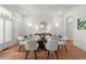 Bright formal dining room with hardwood floors, white trim, and glass table at 303 Rolling Rock Se Rd, Marietta, GA 30067