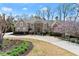 Stately stone and stucco home with well-manicured landscaping and circular driveway at 303 Rolling Rock Se Rd, Marietta, GA 30067