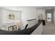 Upper foyer featuring a large decorative chandelier, transom windows, and railing with black accents at 303 Rolling Rock Se Rd, Marietta, GA 30067