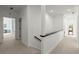 Hallway with carpeted flooring and white walls leading to a room with a desk at 303 Rolling Rock Se Rd, Marietta, GA 30067