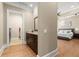 Hallway view of the Primary suite, with a laundry room, featuring granite counters and dark cabinets at 303 Rolling Rock Se Rd, Marietta, GA 30067