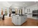 Open concept kitchen with large island, stainless steel appliances, and views of the living room at 303 Rolling Rock Se Rd, Marietta, GA 30067