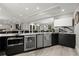 Modern basement kitchen with sleek cabinets, a wine fridge, stainless appliances, and a stylish backsplash at 303 Rolling Rock Se Rd, Marietta, GA 30067