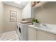 Efficient laundry room with appliances, ample cabinet storage, and a sink for added convenience at 303 Rolling Rock Se Rd, Marietta, GA 30067