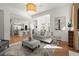 Open-concept living room flowing into kitchen and dining area, with natural light and modern furnishings at 303 Rolling Rock Se Rd, Marietta, GA 30067