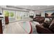 Open living room with hardwood flooring, a modern rug, and large windows at 303 Rolling Rock Se Rd, Marietta, GA 30067