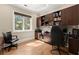 Bright office with custom built-ins, hardwood floors and a large window providing natural light at 303 Rolling Rock Se Rd, Marietta, GA 30067
