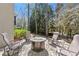 Cozy outdoor seating area with a stone paver patio and firepit, perfect for relaxing or entertaining at 303 Rolling Rock Se Rd, Marietta, GA 30067