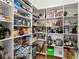 Walk-in pantry with ample shelving for optimal storage of goods and kitchen appliances at 303 Rolling Rock Se Rd, Marietta, GA 30067