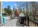 Inviting patio featuring a grill, outdoor seating, and pool view, perfect for entertaining at 303 Rolling Rock Se Rd, Marietta, GA 30067