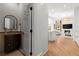 View of powder room from hallway showcasing vanity and mirror in a bright setting at 303 Rolling Rock Se Rd, Marietta, GA 30067