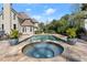 The backyard features a luxurious pool with a hot tub and a serene outdoor space at 303 Rolling Rock Se Rd, Marietta, GA 30067
