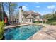 Backyard swimming pool with attached hot tub and patio area for outdoor lounging at 303 Rolling Rock Se Rd, Marietta, GA 30067