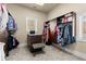 Spacious walk-in closet featuring custom shelving, center island, natural light, and carpeting at 303 Rolling Rock Se Rd, Marietta, GA 30067