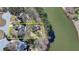 Aerial view highlighting the home's waterfront location and proximity to the lake, surrounded by mature trees at 4852 Jacobs Cove Pt, Buford, GA 30519
