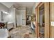 Bathroom with stone floors, dual vanities, walk-in shower and dressing closet at 4852 Jacobs Cove Pt, Buford, GA 30519