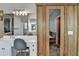 Bathroom with dual sinks, natural stone accents, and walk-in sauna at 4852 Jacobs Cove Pt, Buford, GA 30519