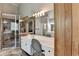 Bathroom with dual sinks, natural stone accents, and walk-in shower at 4852 Jacobs Cove Pt, Buford, GA 30519