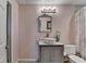 Bathroom featuring a vessel sink, decorative mirror, and floral shower curtain at 4852 Jacobs Cove Pt, Buford, GA 30519