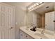 Bright bathroom with double sinks, large mirror, and shower in background at 4852 Jacobs Cove Pt, Buford, GA 30519