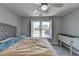 Comfortable bedroom with neutral walls, double window, and ceiling fan at 4852 Jacobs Cove Pt, Buford, GA 30519