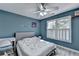 Cozy bedroom with a work station, large window, and wood look flooring at 4852 Jacobs Cove Pt, Buford, GA 30519