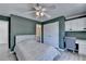 Stylish bedroom with closet, built-in shelves, work station, and large window at 4852 Jacobs Cove Pt, Buford, GA 30519