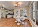 Bright dining area with hardwood floors, a modern light fixture, and large windows offering scenic views at 4852 Jacobs Cove Pt, Buford, GA 30519