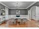 Dining room features modern chandelier, wainscotting, and hardwood flooring at 4852 Jacobs Cove Pt, Buford, GA 30519