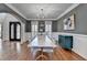 Dining room features modern chandelier, wainscotting, and hardwood flooring at 4852 Jacobs Cove Pt, Buford, GA 30519