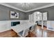 Dining room features modern chandelier, wainscotting, and hardwood flooring at 4852 Jacobs Cove Pt, Buford, GA 30519