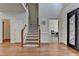 Bright foyer boasts hardwood floors, staircase, and an ornate front door at 4852 Jacobs Cove Pt, Buford, GA 30519