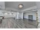Spacious great room featuring a chandelier, hardwood floors, and decorative columns for a stylish and open layout at 4852 Jacobs Cove Pt, Buford, GA 30519