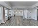 Spacious great room featuring hardwood floors, chandelier, and decorative columns for a stylish and open layout at 4852 Jacobs Cove Pt, Buford, GA 30519