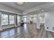 Bright great room with large windows, hardwood floors, chandelier, and decorative columns for a stylish open space at 4852 Jacobs Cove Pt, Buford, GA 30519
