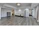 Spacious great room featuring chandelier, hardwood floors, couches, and white walls creating an elegant living space at 4852 Jacobs Cove Pt, Buford, GA 30519