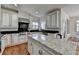 Spacious kitchen with a center island, stainless steel appliances, granite countertops and white cabinetry at 4852 Jacobs Cove Pt, Buford, GA 30519