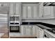 Close-up of kitchen featuring stainless steel appliances, granite countertops, and custom cabinetry at 4852 Jacobs Cove Pt, Buford, GA 30519