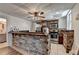 Modern kitchen featuring stone walls, bar seating, and stainless-steel appliances for a stylish and functional space at 4852 Jacobs Cove Pt, Buford, GA 30519