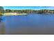 A wide shot of a tranquil lake with tree-lined shores under a bright sky at 4852 Jacobs Cove Pt, Buford, GA 30519