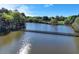 Picturesque view of the lake featuring a wooden bridge walkway, great for outdoor activities at 4852 Jacobs Cove Pt, Buford, GA 30519