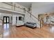 Spacious living room with hardwood floors, a staircase leading to the upper level and comfortable seating at 4852 Jacobs Cove Pt, Buford, GA 30519