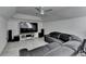 Living room with a large, comfortable, and modern sectional sofa facing an entertainment center with a wide-screen TV at 4852 Jacobs Cove Pt, Buford, GA 30519