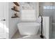 Modern bathroom featuring a soaking tub, floating shelves, and natural light at 790 Denards Se Ml, Marietta, GA 30067