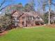 Traditional brick home featuring well-maintained landscaping and a circular driveway at 790 Denards Se Ml, Marietta, GA 30067