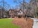 Classic brick house with a green lawn and mature trees offering a sense of privacy at 790 Denards Se Ml, Marietta, GA 30067